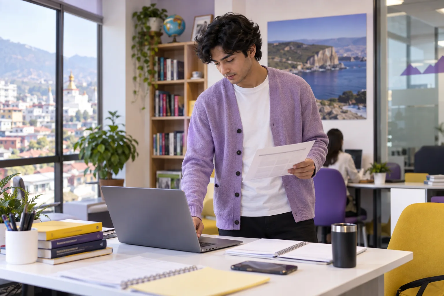 Young Nepali man with wavy hair comparing a personal study budget worksheet and university tuition information on a laptop for Canada study planning