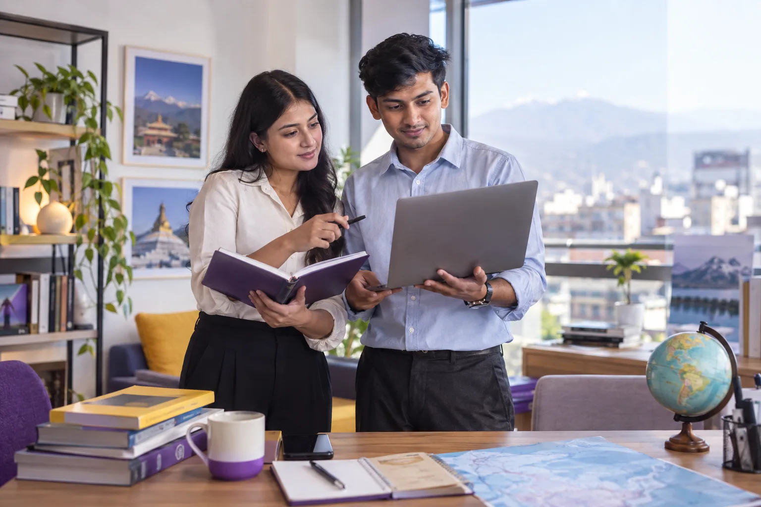 Two Nepali students, one woman and one man comparing Canadian university courses and intake options using a laptop and notebook for Canada study planning