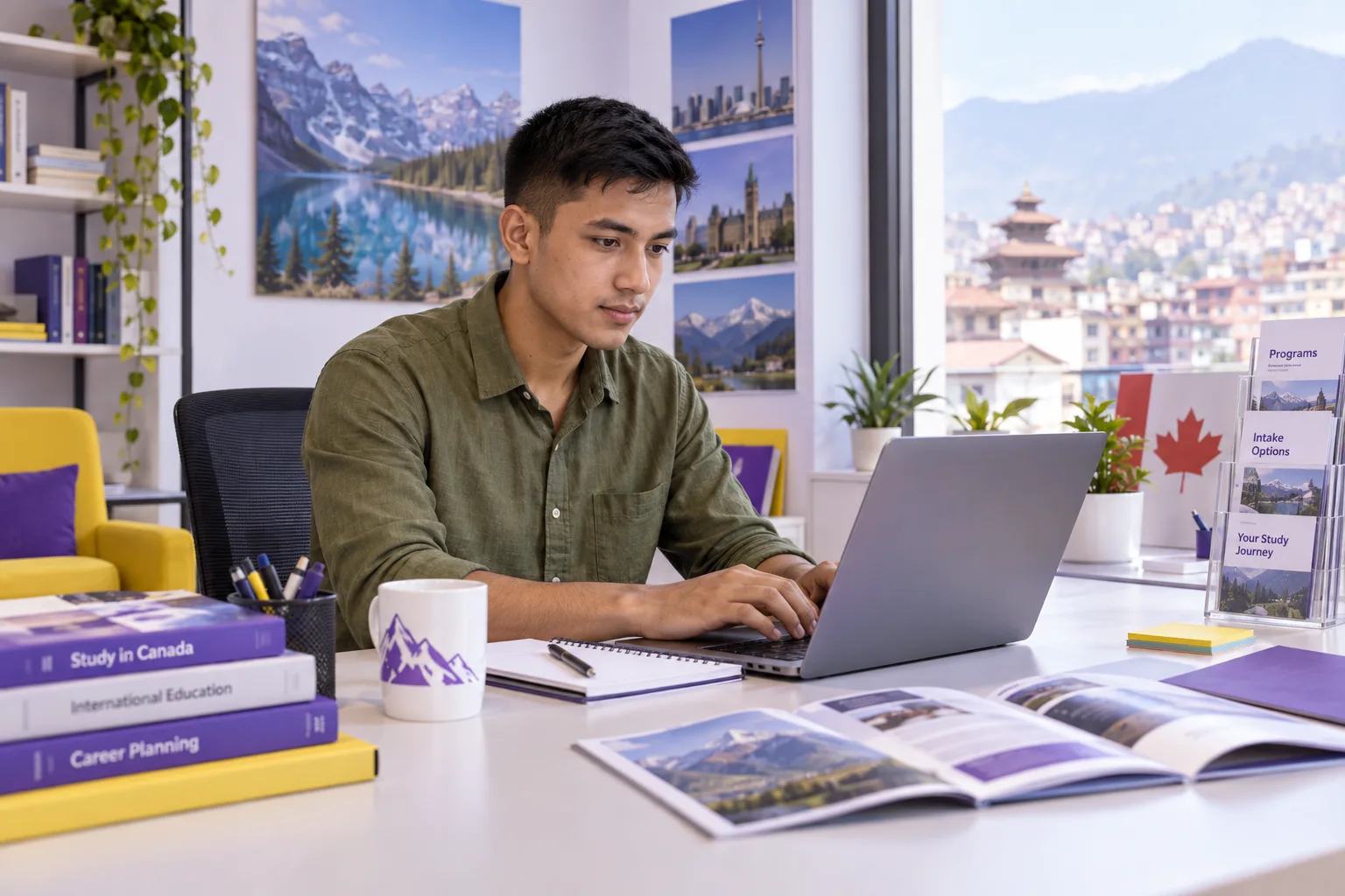 Young Nepali man with cropped hair comparing Canadian university courses and intake options using a laptop and notebook for Canada study planning