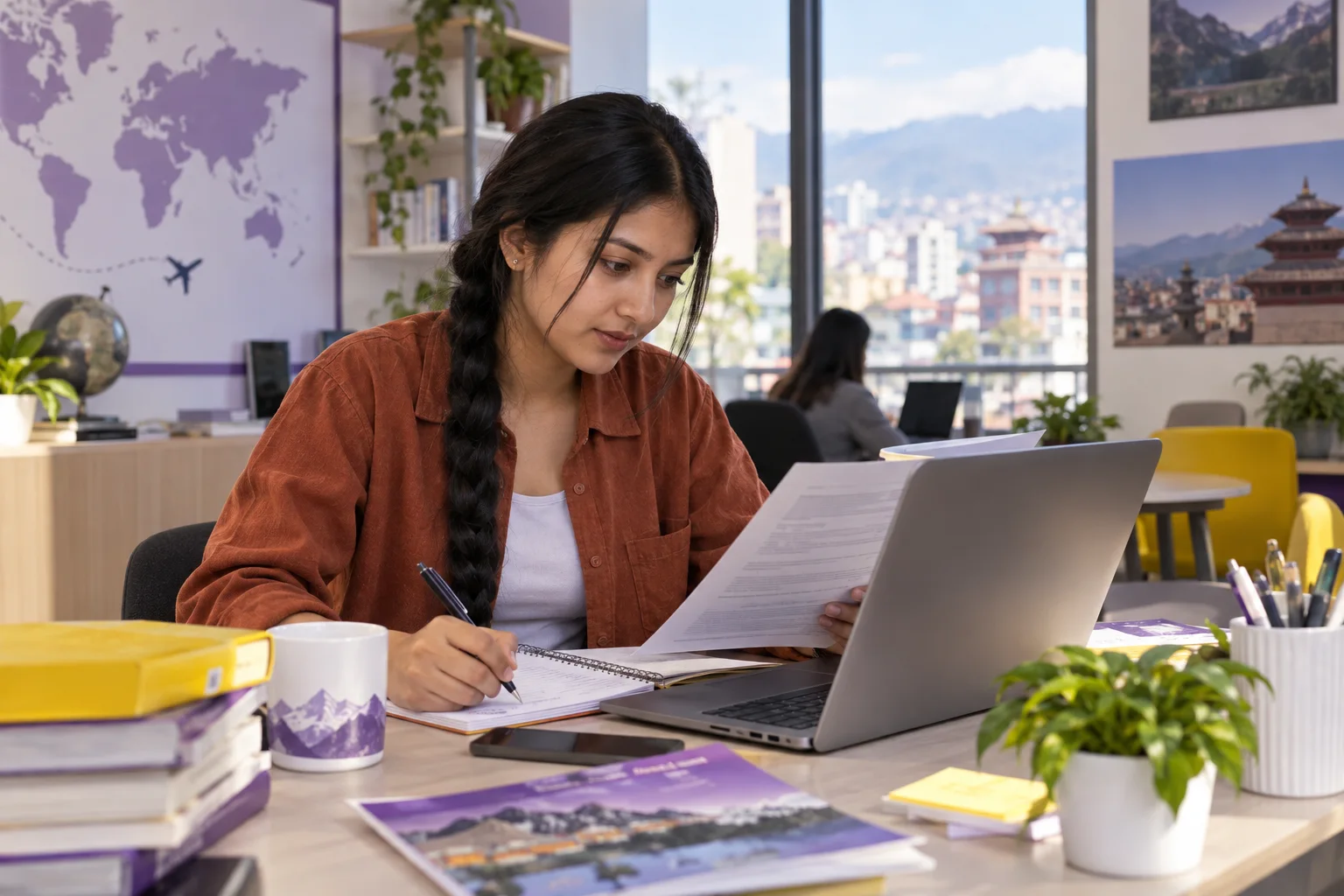 Young Nepali woman with a long braid comparing a personal study budget worksheet and university tuition information on a laptop for Canada study planning