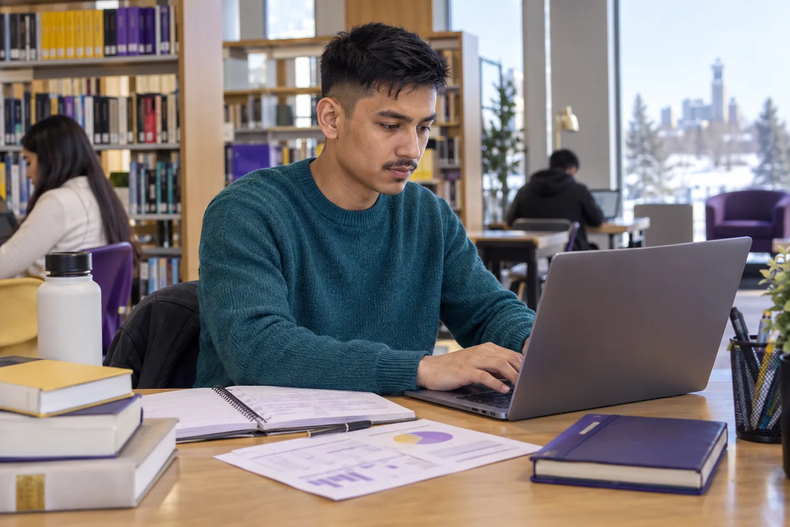 Young Nepali man with cropped hair comparing a personal study budget worksheet and university tuition information on a laptop for Canada study planning