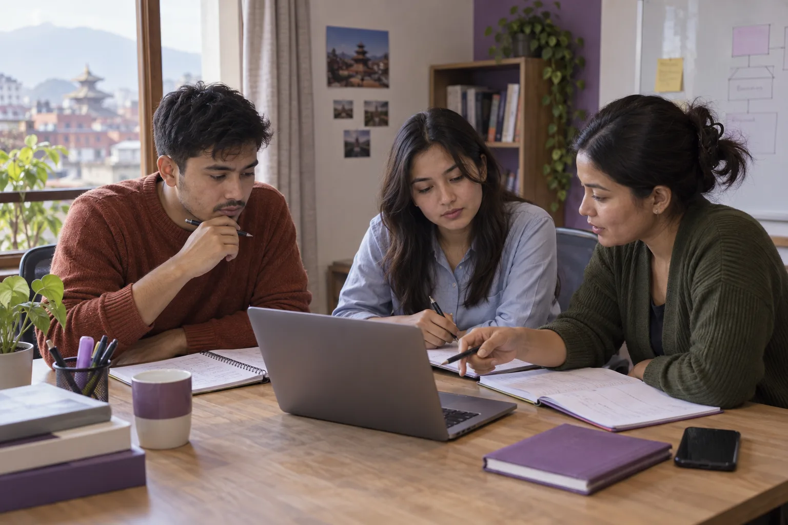 Three Nepali GMAT learners discussing practice questions around a laptop in Kathmandu