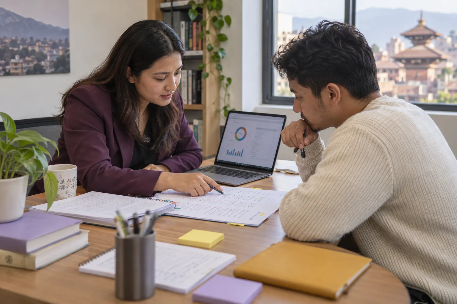 Nepali GMAT tutor and student reviewing mock test notes and a laptop dashboard