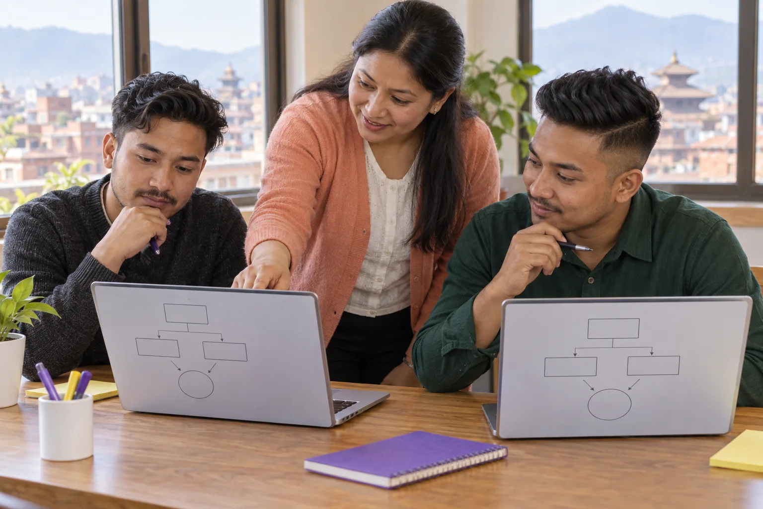GMAT learners and teacher reviewing problem-solving diagrams on laptops