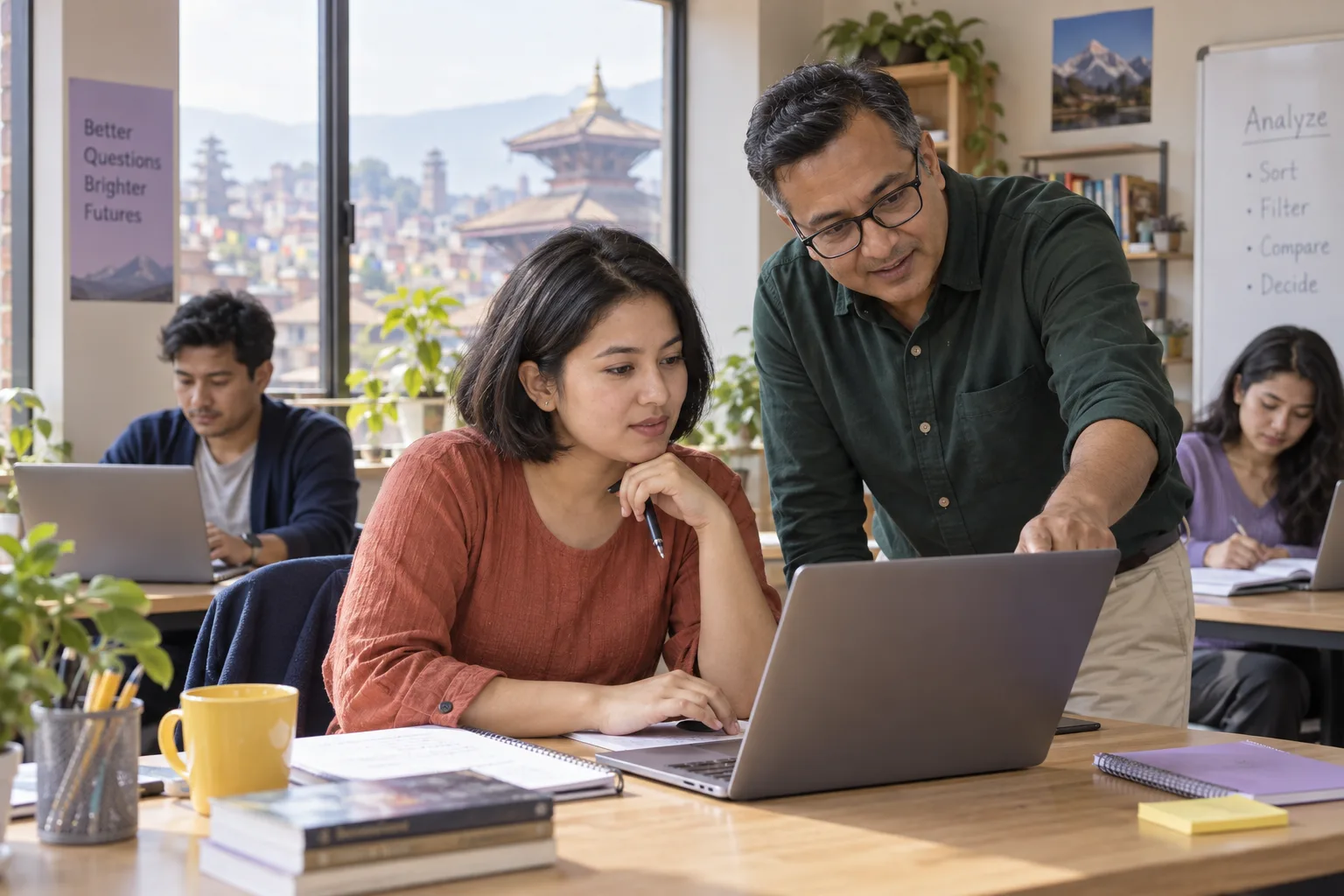 Tutor guiding a GMAT Table Analysis learner at a classroom laptop