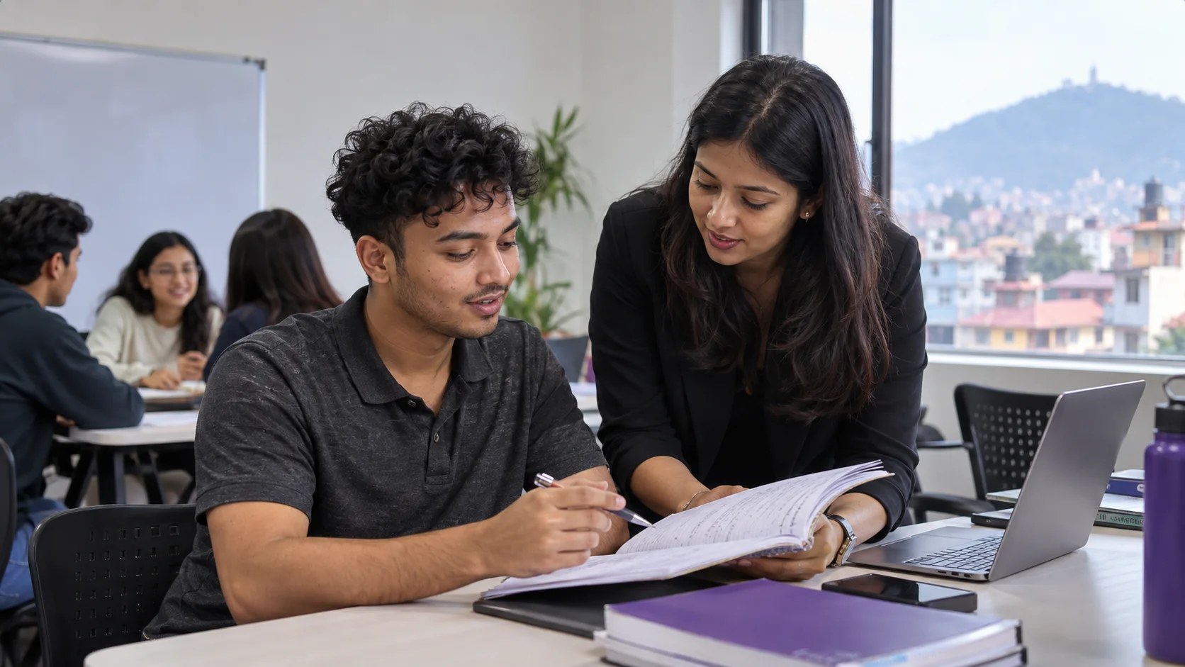A Kathmandu student and tutor reviewing a GRE study notebook for GRE preparation.