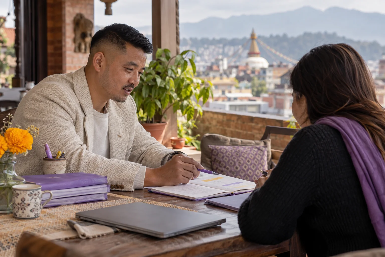 Tutor reviews IELTS vocabulary practice with a student on a terrace