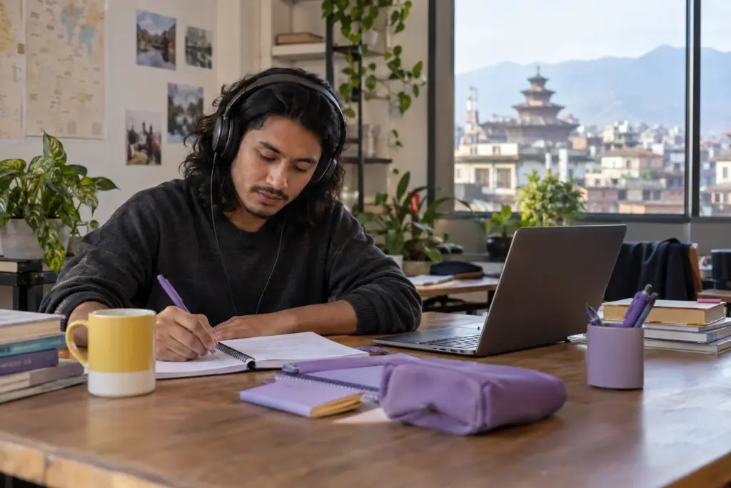 IELTS learner practises listening matching questions with headphones and notes in Kathmandu