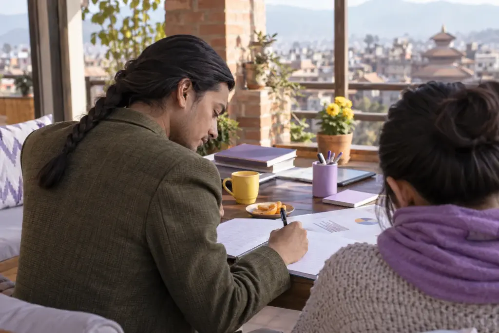 IELTS learner writes a Task 1 overview while studying on a terrace