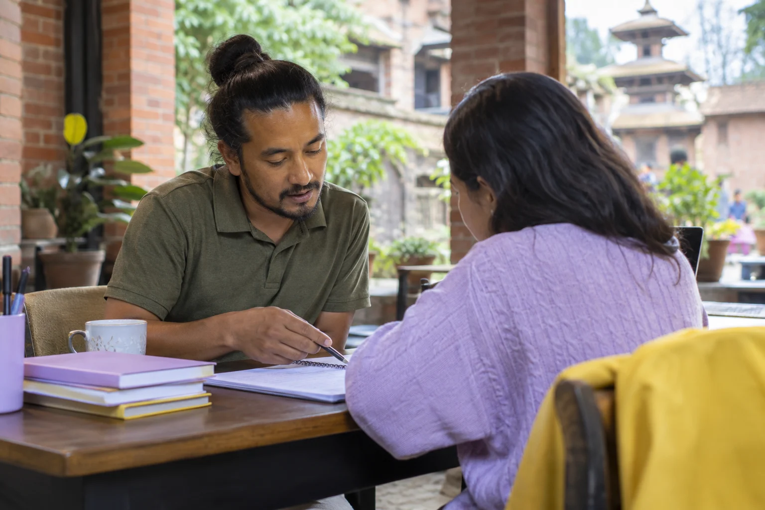 IELTS UK below-degree study English requirement — adult learner and tutor reviewing study notes