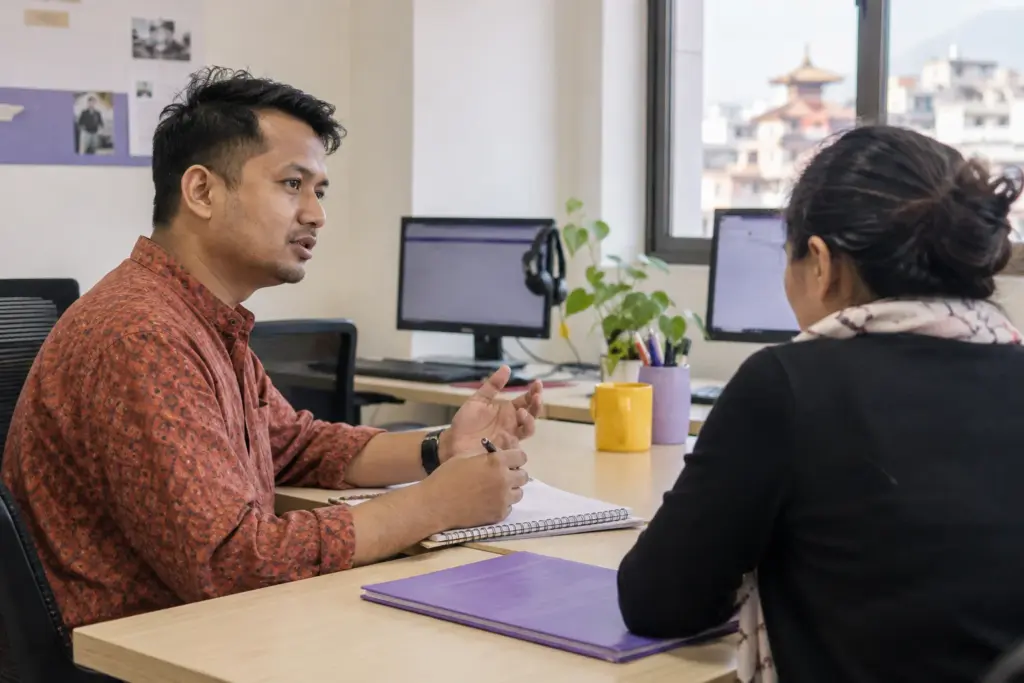 IELTS Life Skills A1 pass or fail scoring — tutor and learner practising an everyday conversation