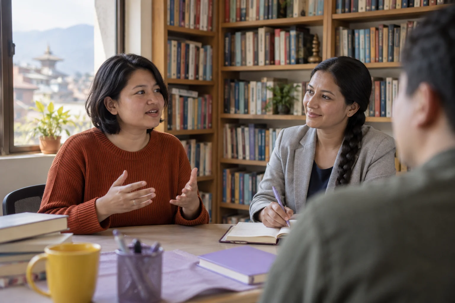 IELTS Life Skills A1 home mock-test review — two learners practising dialogue with a feedback notebook