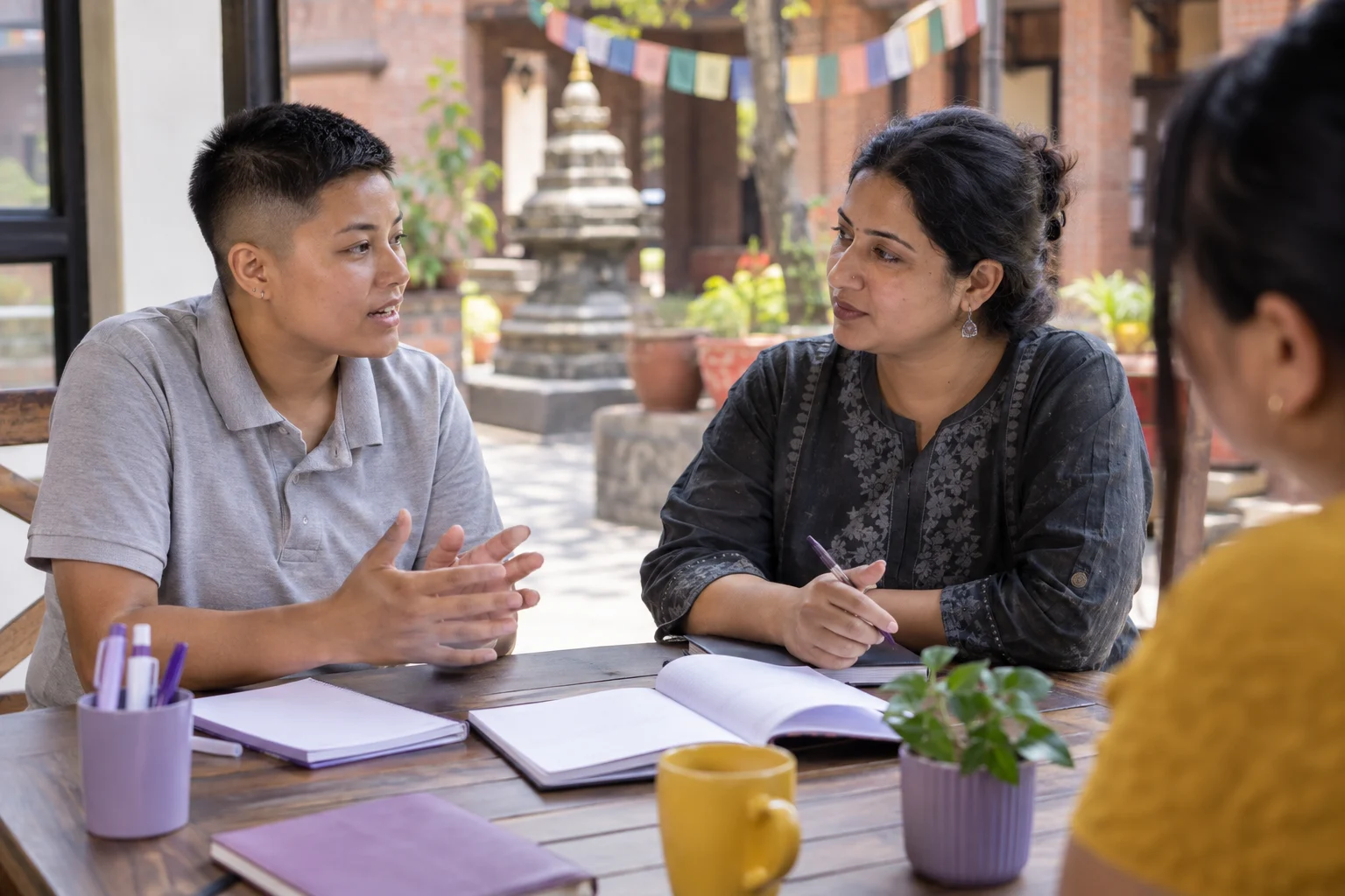 IELTS Life Skills B1 test format — two learners practising dialogue with a feedback notebook